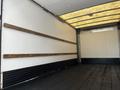 A 2016 Isuzu NQR box truck interior with wooden support beams and a black rubberized floor