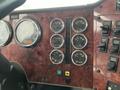 Dashboard of a 2003 International 5600i featuring various gauges for speed RPM fuel temperature and pressure along with switches for controls and features