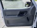 The interior door panel of a 2010 Ford Ranger featuring a handle window crank and door lock button in a gray finish