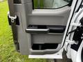 A 2017 Ford F-150 door panel featuring a gray interior with a black handle and storage compartment
