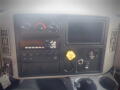 Dashboard of a 2016 International WorkStar 7500 featuring gauges switches a screen and a yellow key fob