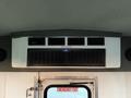 Interior view of a 2014 Ford E-450 with air vents and emergency exit sign visible on the wall above the door
