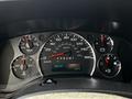 Dashboard of a 2013 Chevrolet Express displaying gauges for speed fuel level temperature and oil pressure with a digital odometer reading 302347 km and outside temperature at 14°C