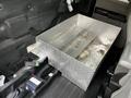 A metal tool chest with a diamond plate finish sits inside the back of a 2016 Ford F-150