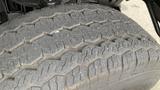 Close-up of a tire from a 2017 Chevrolet Express Quigley 4x4 showing detailed tread patterns designed for off-road traction