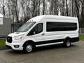 A white 2021 Ford Transit van with a high roof and large windows featuring black accents and round bumper lights on the front