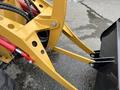Close-up of the arm and bucket attachment of a 2024 AGT Industrial KRW23 Mini Loader showcasing its hydraulic lines and mechanical components