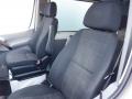 Two black upholstered seats in the front cabin of a 2016 Mercedes-Benz Sprinter van