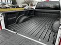 A 2020 Ford F-350 SD truck bed showing a textured black liner and wheel wells