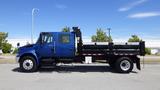 A blue 2012 International DuraStar 4300 truck with a black flatbed and side rails is displayed in profile position