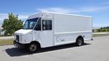 A white 2011 Ford Econoline delivery truck with a boxy shape and side entrance door