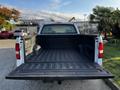 A 2008 Ford F-150 XL with an open truck bed showing a black liner and white exterior