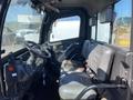 Interior view of a 2018 Kubota RTV XL 1100 C featuring a steering wheel and two seats with a console on the left side