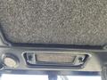 The interior roof of a 2010 Kubota F3990 featuring a textured black fabric and control buttons on the side