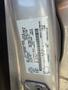 Close-up of a 2014 Ford Escape vehicle identification label showing specifications and details about the car