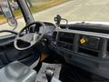Interior view of a 2006 Hino 268 featuring the steering wheel dashboard controls and a mounted device on the dashboard