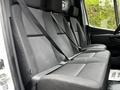 A 2020 Mercedes-Benz Sprinter interior showing a row of black fabric seats with seatbelts fastened