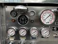 Dashboard of a 1991 Sutphen Deluge featuring gauges for RPM temperature and pressure with a shiny metallic finish and labeled dials