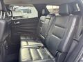 A 2015 Dodge Durango showcasing the interior with black leather seats in the second row featuring a three-seat configuration and adjustable headrests