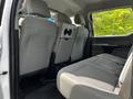 Interior view of a 2017 Ford F-250 SD showing the back seats which are upholstered in gray fabric with a bench layout and folded seatbacks