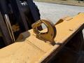 A close-up of a yellow metal hook attachment on a 2013 John Deere 710K heavy machinery bucket