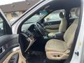 Interior of a 2016 Ford Explorer featuring beige seats a steering wheel a center console and various controls