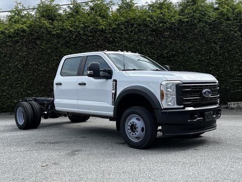 A white 2024 Ford F-550 chassis cab with a spacious crew cab design and no bed attached, showcasing its front and side profile