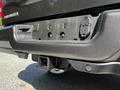 A black 2022 RAM 3500 pickup truck's rear bumper showing the hitch receiver and electrical connections