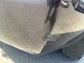A 2016 Chevrolet Tahoe with noticeable scratches and scuffs on the rear bumper