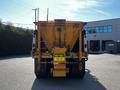A 2005 Volvo VND 122 truck with a large yellow trailer prominently displaying a warning sign that reads KEEP BACK 15 m