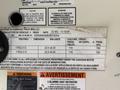 A 2016 International CE300 vehicle specification label detailing tire dimensions, rim size, cold inflation pressure, and other technical information