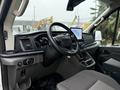 Interior view of a 2023 Ford Transit showing the steering wheel dashboard and controls with a touchscreen display