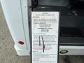 A 2013 Chevrolet Express with a visible wheelchair and standee lift control panel displaying safety instructions and warnings