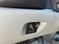 A control panel with two knobs and a button indicating settings for a 2013 Chevrolet Silverado 1500