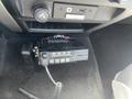 A 2012 Ford F-150 interior featuring a mounted radio unit with a display and microphone connected by a coiled cord