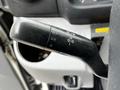A black turn signal and headlight control lever from a 2014 Hino 195 featuring indicators for turn signals headlight settings and high beam