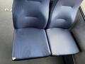 Two blue seats from a 2017 Chevrolet Express with visible wear and tear on the surface