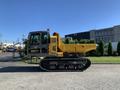 A yellow and black 2022 TerraMac Tracked Dump with a tracked undercarriage and a large dumping bed on the back