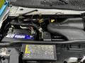 A 2009 Ford Econoline engine compartment featuring a battery hoses and various engine components