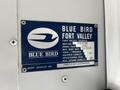A blue and white identification plate for a 2022 Blue Bird Vision bus displaying information about the manufacturer and specifications