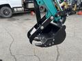 Close-up of a 2024 AGT Industrial Green QH13R Mini Excavator's bucket and claw attachment showing its mechanical features and design
