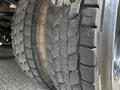 Close-up of a worn tire from a 2022 Blue Bird BB Conventional bus showing cracked tread patterns