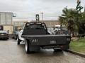 A 2022 Ford F-550 with a flatbed design parked at an angle showing the rear and side view