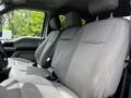 Interior view of the front seats of a 2020 Ford F-350 Super Duty with fabric upholstery and a spacious layout