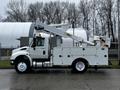 A white 2013 International DuraStar truck with an elevated aerial lift on its side and a service body with storage compartments