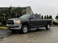 A 2020 RAM 3500 pickup truck with a dark gray exterior and chrome accents parked at an angle showcasing its cab and long bed