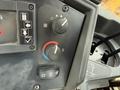 Control panel with knobs for temperature and ventilation settings on a John Deere 310SJ 4x4 Wheel Loader