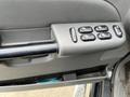 Close-up view of the driver's side door control panel of a 2004 Ford Explorer Sport Trac showing window controls and door lock buttons