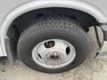 Close-up of a 2017 Chevrolet Express tire with a metallic wheel showing multiple lug nuts and a textured tread design