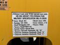 Label on a yellow panel featuring a list of hydraulic fluid specifications and brands for a 2015 Freightliner M2 106 truck